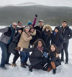 a group of people posing for a picture in the snow