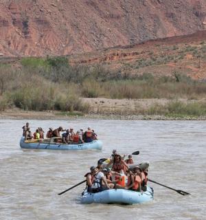 a group of people on rafts on a river