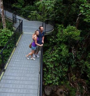 a man and a woman standing on a walkway