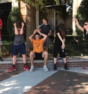 a group of young people sitting on a curb