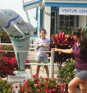 a woman and a young child standing in front of aventricular