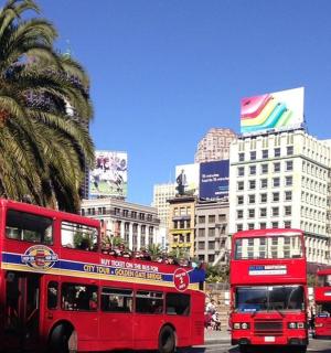 three red double decker buses driving down a city street