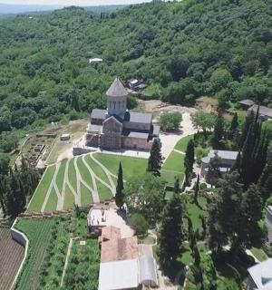 an aerial view of a building on top of a hill