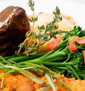a white plate of food with broccoli and meat
