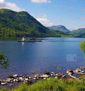 a boat on a lake with mountains in the background