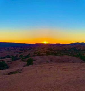 a sunset over ayers rock in the desert