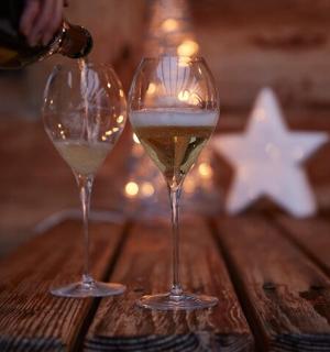 two glasses of wine sitting on a wooden table