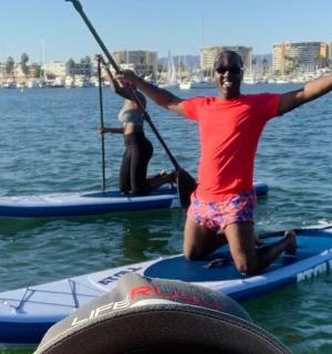 two people are on paddle boards in the water