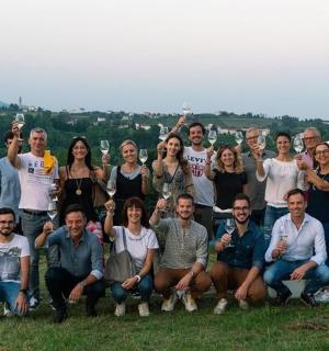 a group of people posing for a picture on a hill