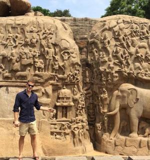 a man standing in front of a statue of an elephant
