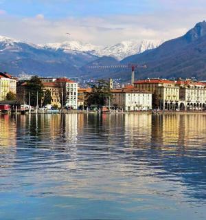a large body of water with buildings and mountains
