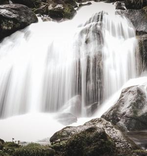 a waterfall with water rushing over rocks