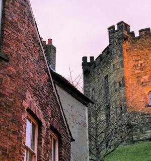 an old brick building next to another brick building