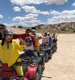 a group of people riding on atvs in the desert