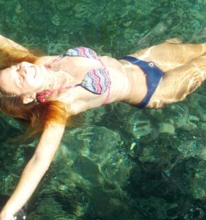 a woman in a bikini swimming in the water