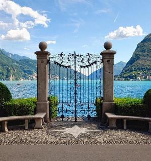 a gate with a bench in front of a body of water