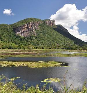a body of water with a mountain in the background