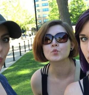 a group of three women standing next to each other