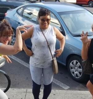 a group of three women standing in a parking lot