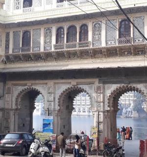 a building with arches and people standing in front of it