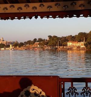 a boat on a body of water with buildings in the background