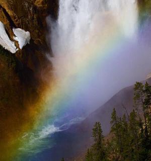 a rainbow in the middle of a waterfall