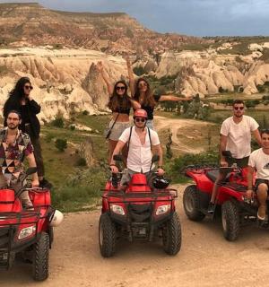 a group of people sitting on atvs in the desert