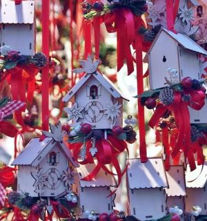 a christmas decoration of white houses and red bows