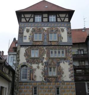 a tall building with a clock tower on a street