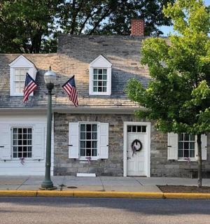 a white house with two american flags in front of it