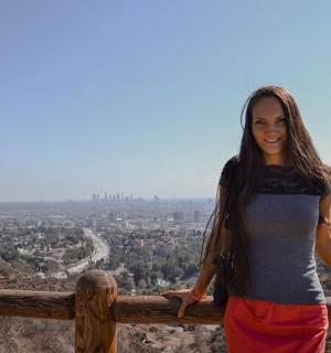 a woman standing on top of a fence
