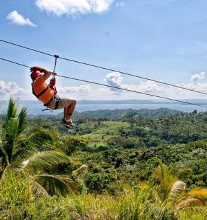 a person on a zip line in the jungle