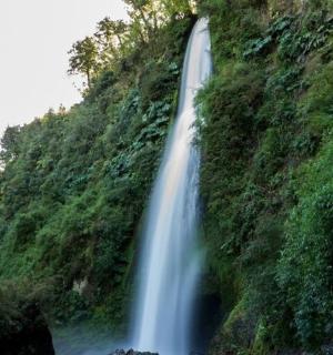 a waterfall on the side of a mountain