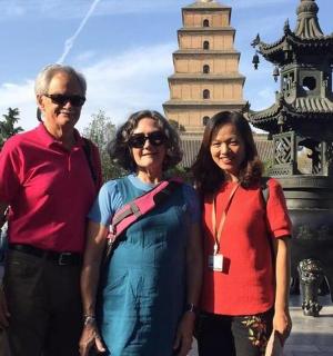 a man and two women standing in front of a tower