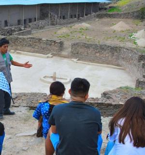 a group of people looking at a man standing in front of a crowd