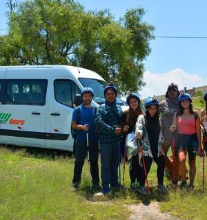 a group of people standing in front of a van