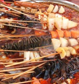 a bowl of food with sticks and other foods