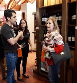 a group of people standing in a wine store