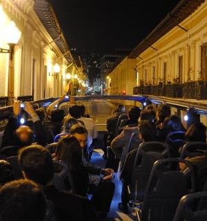 a crowd of people sitting in a bus at night