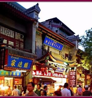 a crowd of people walking in a street with signs