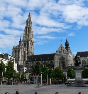 a large cathedral with a clock tower in a city