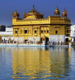 a large yellow building with water in front of it