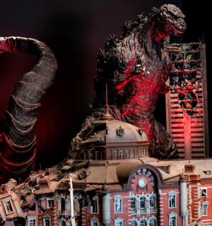 a statue of a dinosaur on top of a building