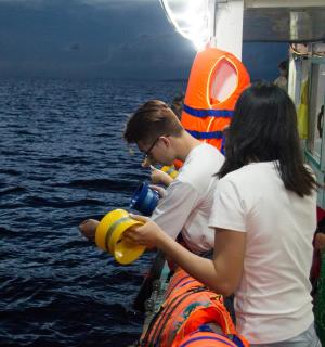a group of people on a boat in the water