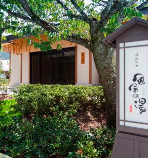 a sign in front of a building with a tree