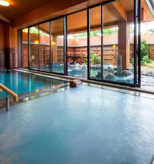 a swimming pool in a building with a large window