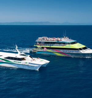 two boats in the water with people on them