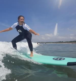 a woman riding a wave on a surfboard in the ocean