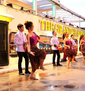 a group of people dancing in front of a train