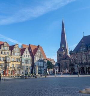 a city street with many buildings and a church